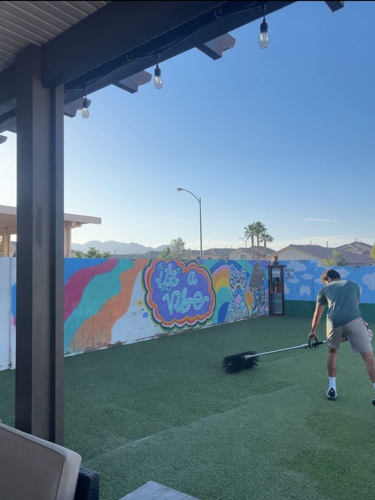 PureGrove technician grooming commercial turf at a Las Vegas venue