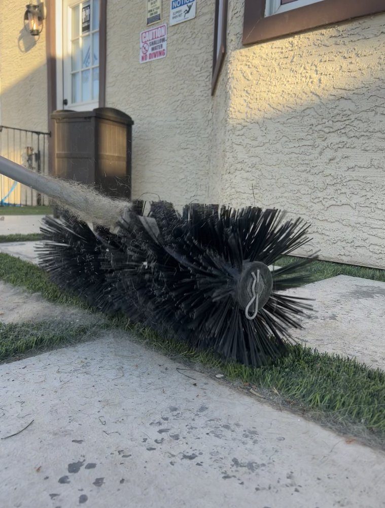 PureGrove power broom lifting embedded debris from artificial turf